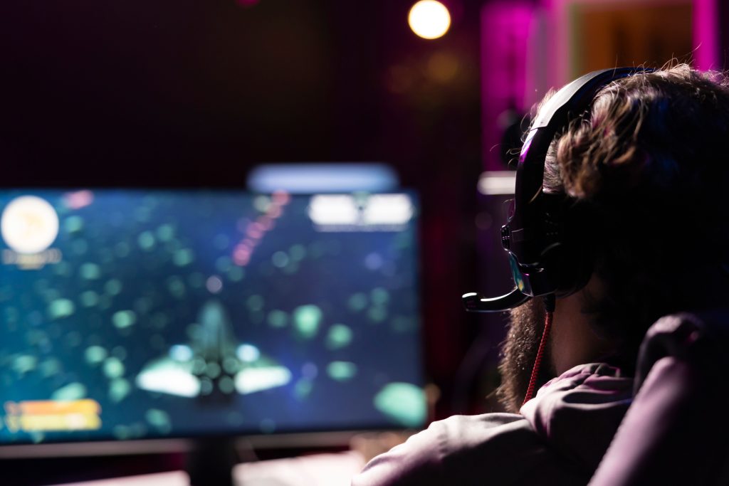 man-using-headphones-communicate-with-teammates-while-gaming-11zon